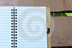 Notebook on the brown bench