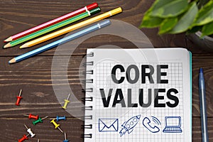 Notebook with a Business notes CORE VALUES on the office table with tools. Concept CORE VALUES with elements of infographics photo