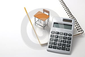 Notebook, calculator, pencil and miniature desk