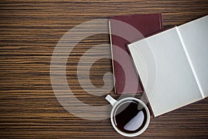 Notebook with coffee on wooden tabel photo