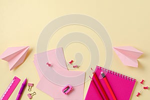 Notebook, colored pencils, ruler, pen, eraser, sharpener and more. School and office stationery on yellow background. Concept back