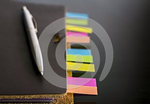Notebook with colorful sticky bookmarks