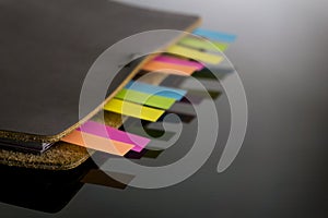 Notebook with colorful sticky bookmarks