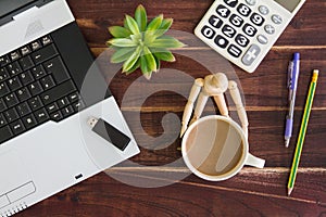 Notebook computer on the desk.Calculators,USB flash drive stick,coffee cup