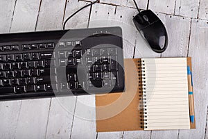 Notebook computer keyboard and mouse on a white table. Office accessories for work