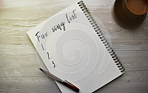 Notebook with a conceptual inscription and a cup of coffee on a table in a cozy cafe