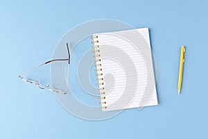 Notebook with copyspace with eyeglasses and pen