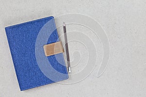 Notebook cover blue denim with empty label on wooden background