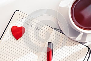 Notebook, cup of tea and heart