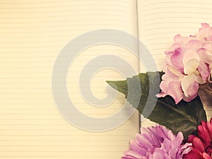 Notebook diary and beautiful flower bouquet with vintage filter