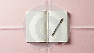 The notebook features rounded corners and a gray ribbon bookmark