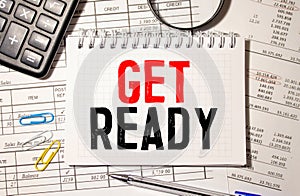Notebook with GET READY word with office tools on white table. business conceptual