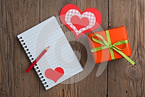 Notebook with gift, pencil and hearts
