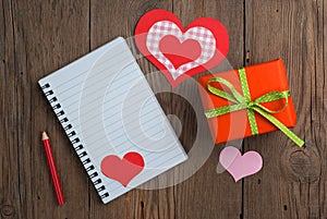 Notebook with gift, pencil and hearts