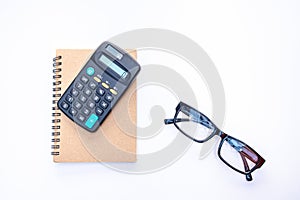 Notebook, glasses and calculator on a white background.