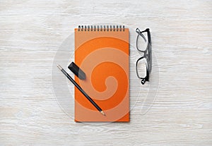 Notebook, glasses, pencil, eraser