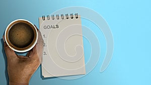 A notebook with goals list text
