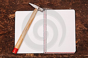 Notebook and hammer on the wooden table