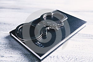 Notebook and handcuffs on the table