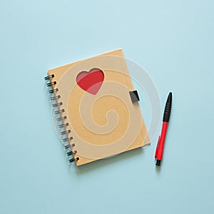 Notebook with heart on the table