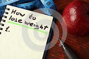 Notebook with how to lose weight sign. photo