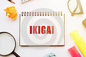 Notebook With Ikigai Next to a Magnifying Glass photo