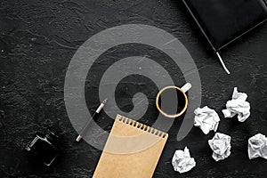 Notebook, ink, dip pen, coffee for writer workplace set on black office background top view mock-up