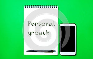 Notebook with the inscription Personal growth, a pen and a telephone. Self-improvement of skills, knowledge, personal qualities