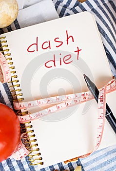 Notebook with inscription and wooden spoon and spatula  wrapped in centimeters.Culinary blog  recipe template  online cooking