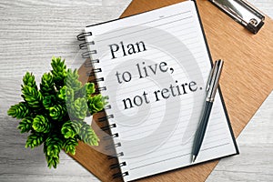 Notebook with Inspirational Quote. Plan to Live not Retire.