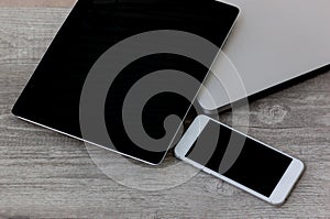 Notebook, laptop, smartphone and tablet set on the wood background