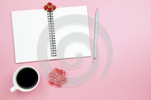 Notebook mobile phone and black coffee white cup on pink background pastel style with copyspace flatlay topview.