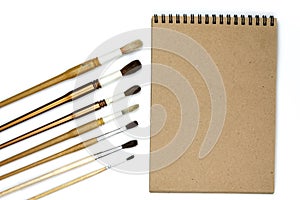 Notebook mock up for artwork with watercolor paints isolated on white background.