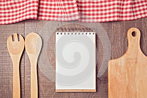 Notebook mock up template with kitchen utensils and tablecloth. View from above