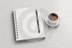 Notebook mockup. Blank notebook, coffee and pencil. Spiral notepad on white wooden desk