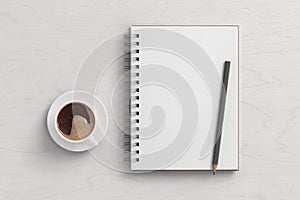 Notebook mockup. Blank notebook, coffee and pencil. Spiral notepad on white wooden desk
