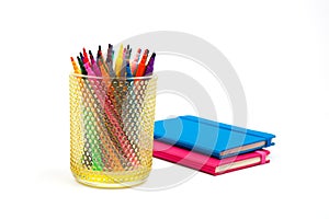 Notebook and multicolored markers on a white background