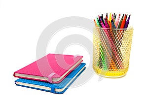 Notebook and multicolored markers on a white background