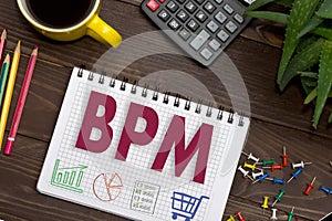 Notebook with a notes BPM on the office table with tools. Concept with elements of infographics