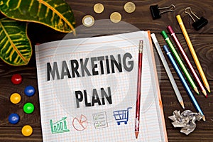 Notebook with a notes MARKETING PLAN on the office table