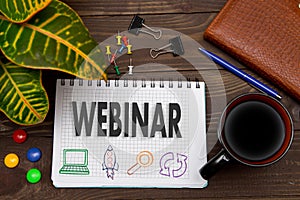 Notebook with a notes WEBINAR on the office table with tools