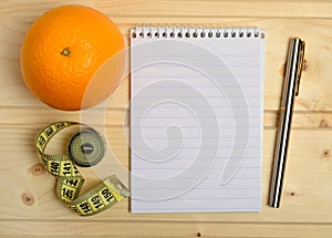 Notebook with orange fruit