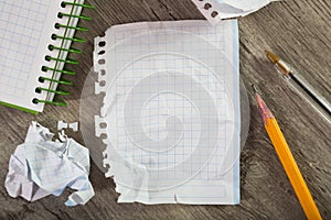 Notebook page with writing materials on the table
