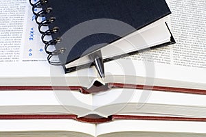 Notebook and Pen on Books