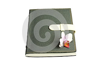 Notebook with pen and flower and orchid