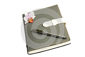 Notebook with pen and flower and orchid