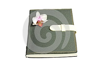 Notebook with pen and flower and orchid