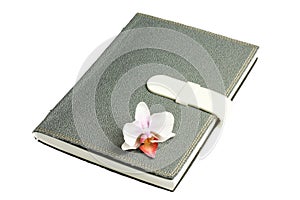 Notebook with pen and flower and orchid
