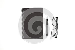 Notebook ,pen and glasses isolated on white