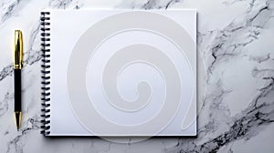 A notebook and pen on a marble surface.